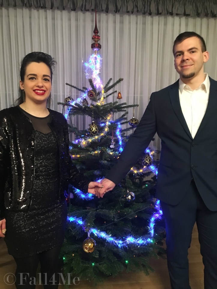 Couple in front of a Christmas tree