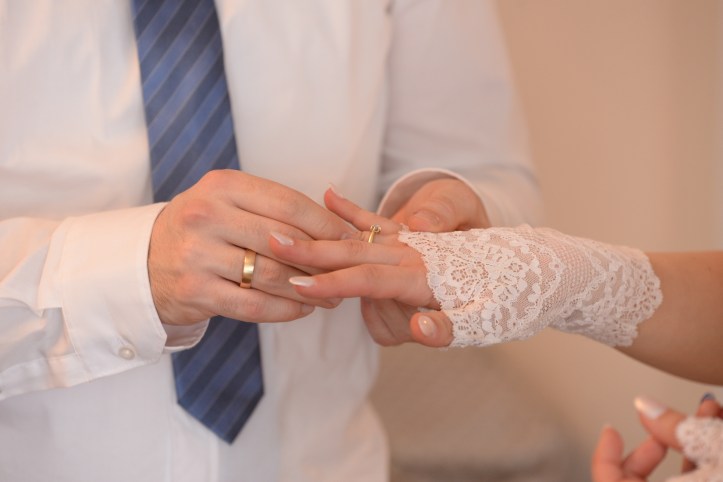 The moment when the groom puts on the wedding ring of his bride