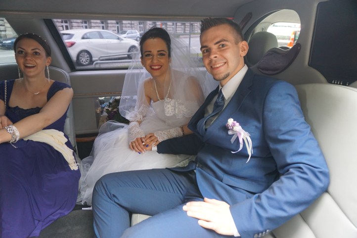 The bridal couple in the limousine