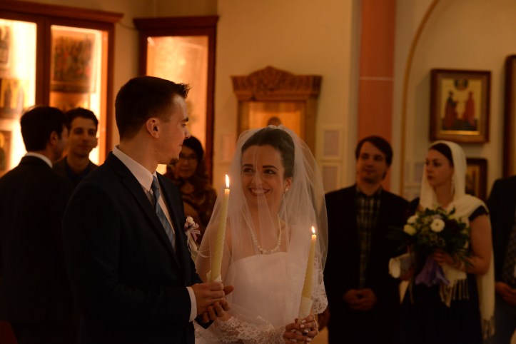 Bride and groom holding candles