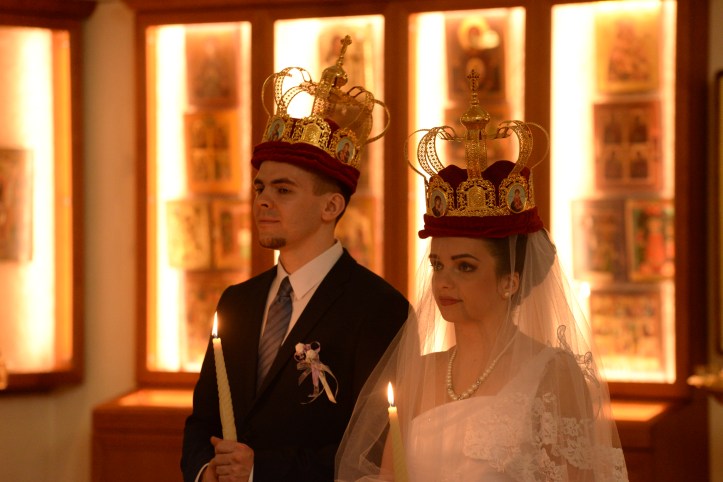 Bride and groon wearing the crowns for the wedding ceremony.