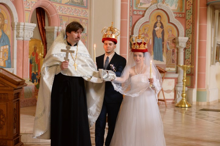 Priest and the bridal couple going around the altar.