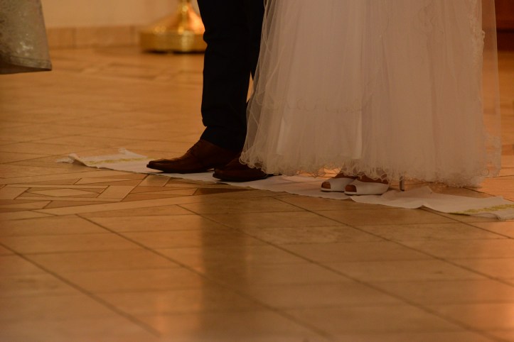 The couple to get married standing on a sash