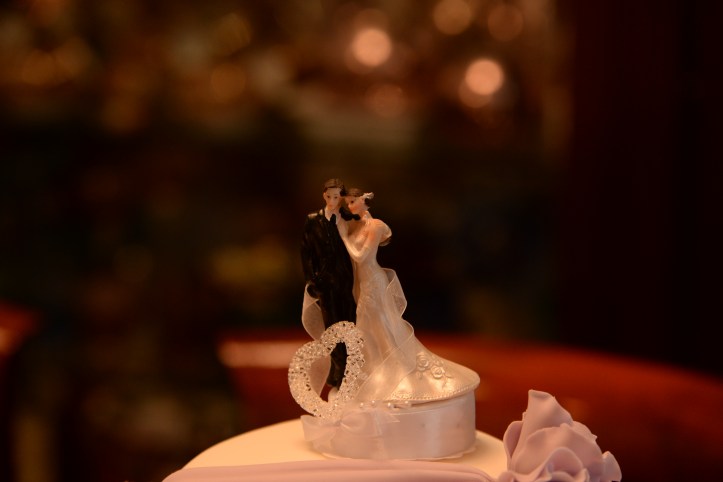 A bridal couple looking like us as cake topper