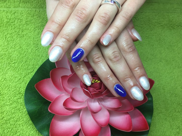 White nails with royal blue on the ring-fingers