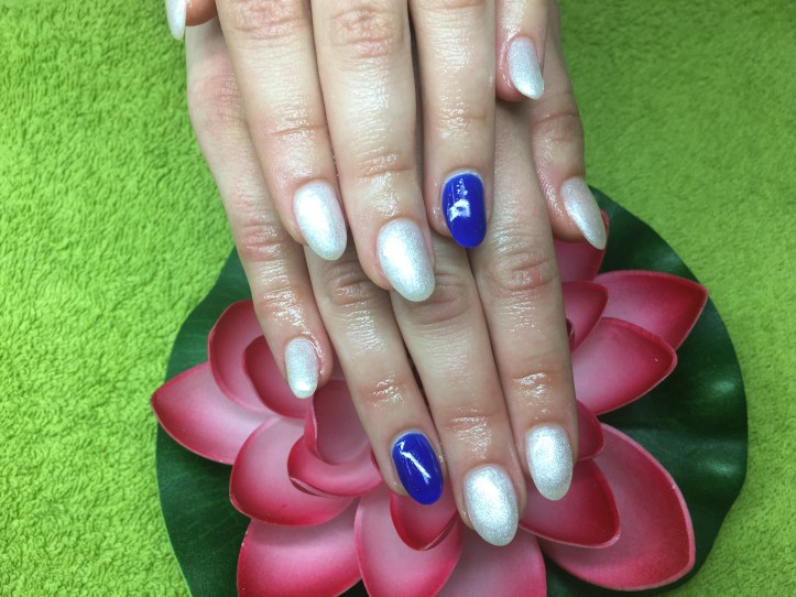 White nails with royal blue on the ring-fingers