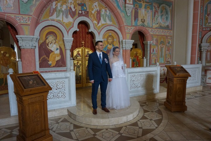 Bride and groom after their wedding on the altar