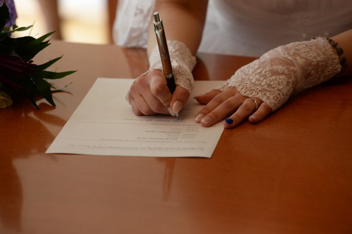 Bride wearing lace gloves in white