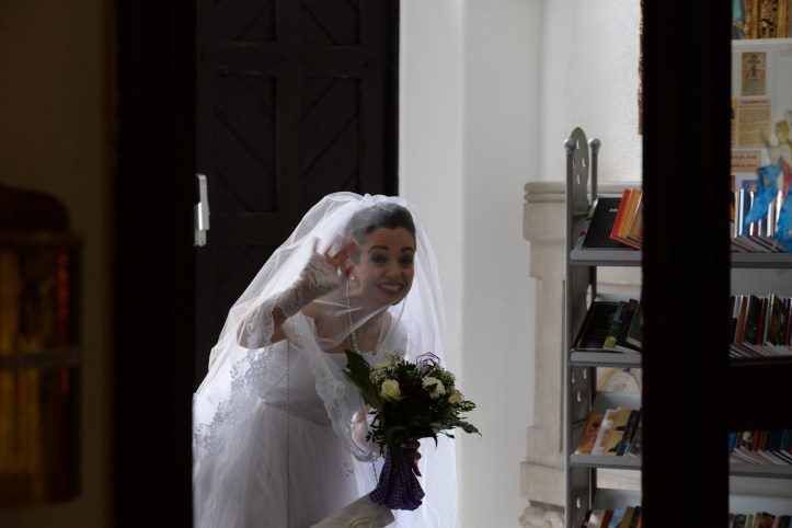 The bride waving and smiling crazy