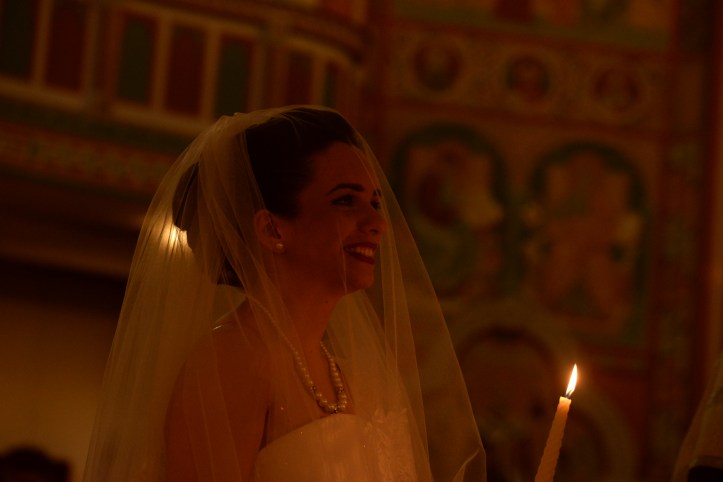 The bride holding a candle speaking her vow