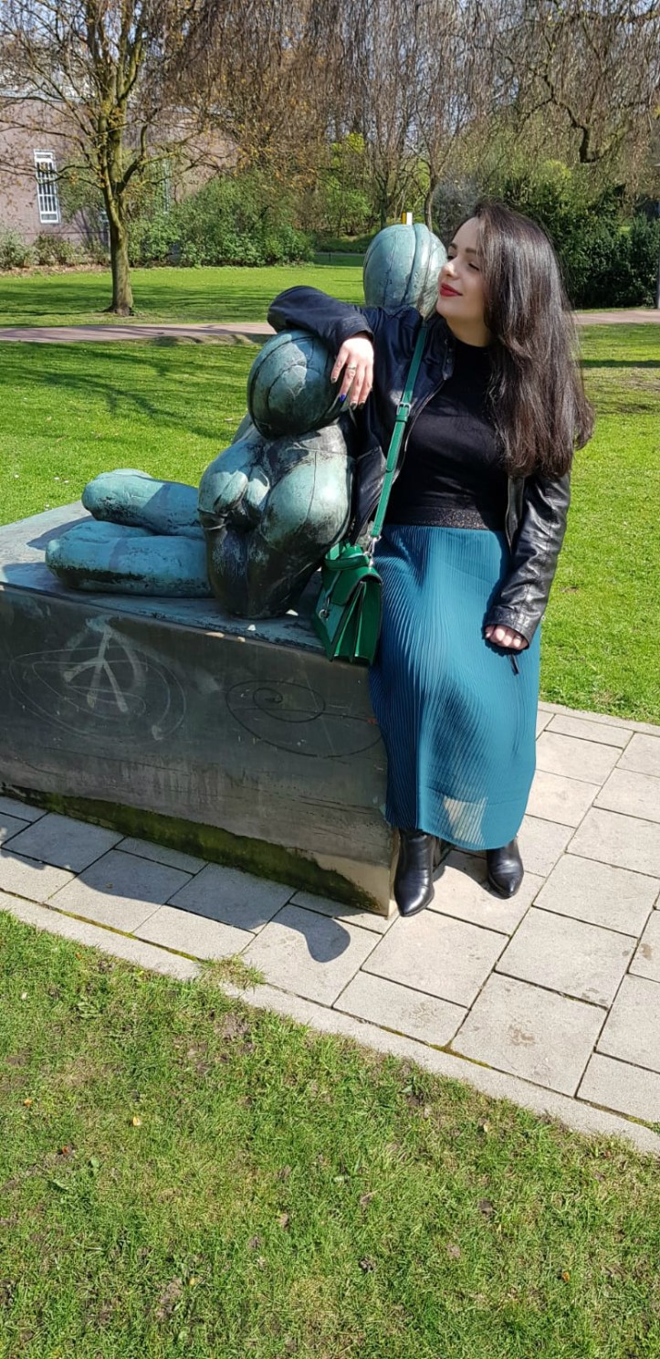 Spring-style in black and green: a leather jacket and a skirt