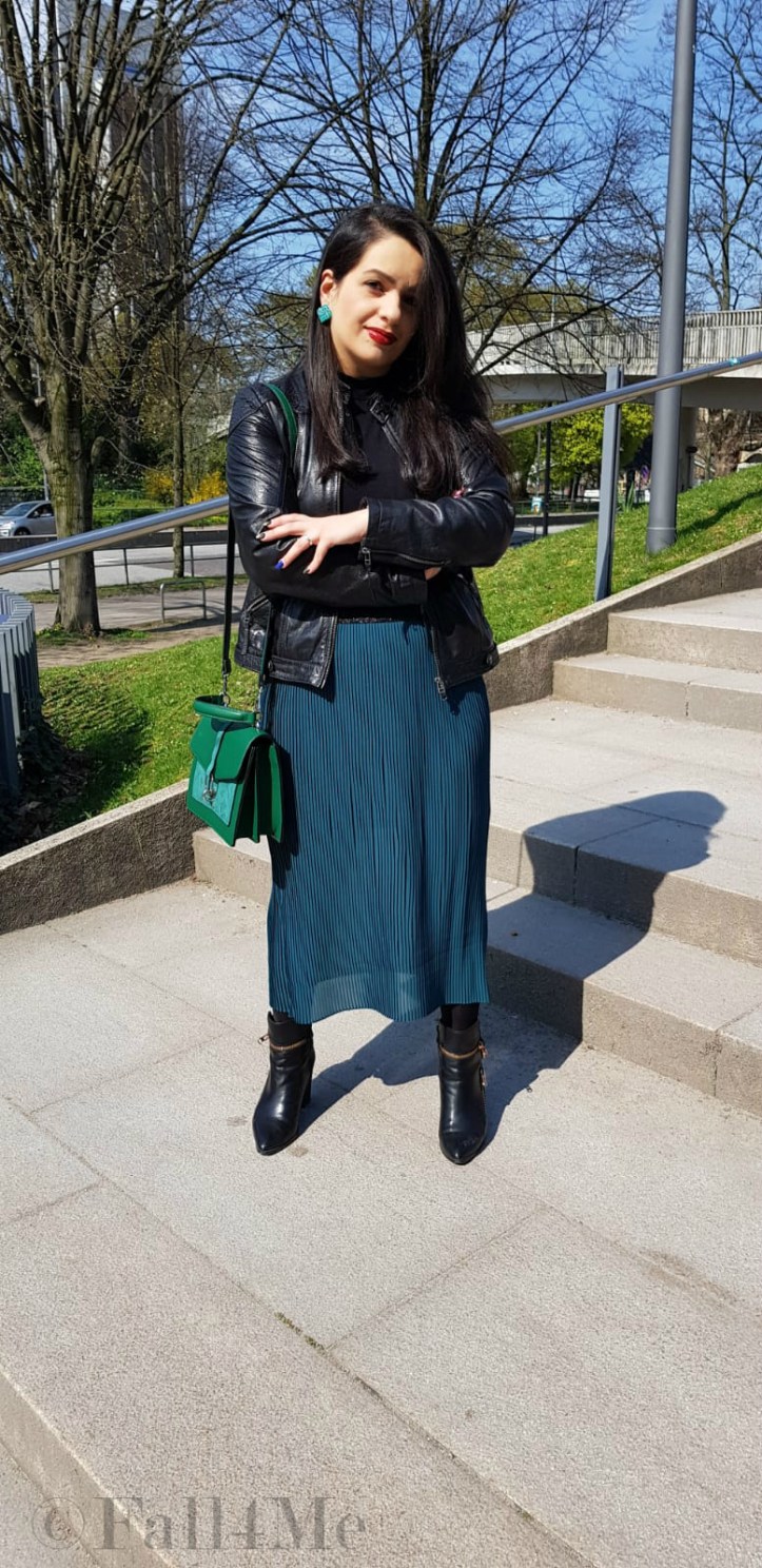 Spring-style in black and green: a leather jacket and a skirt