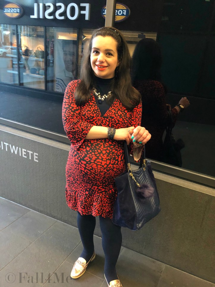 An orange dress worn with navy blue accents