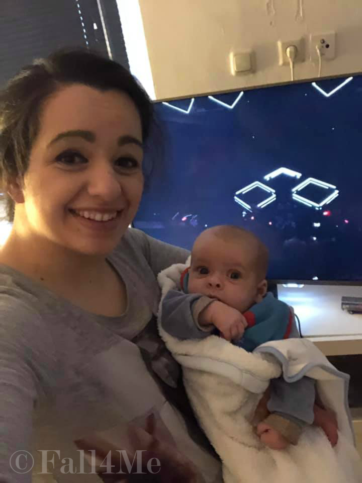 Mother and baby boy in front of the TV watching Eurovision