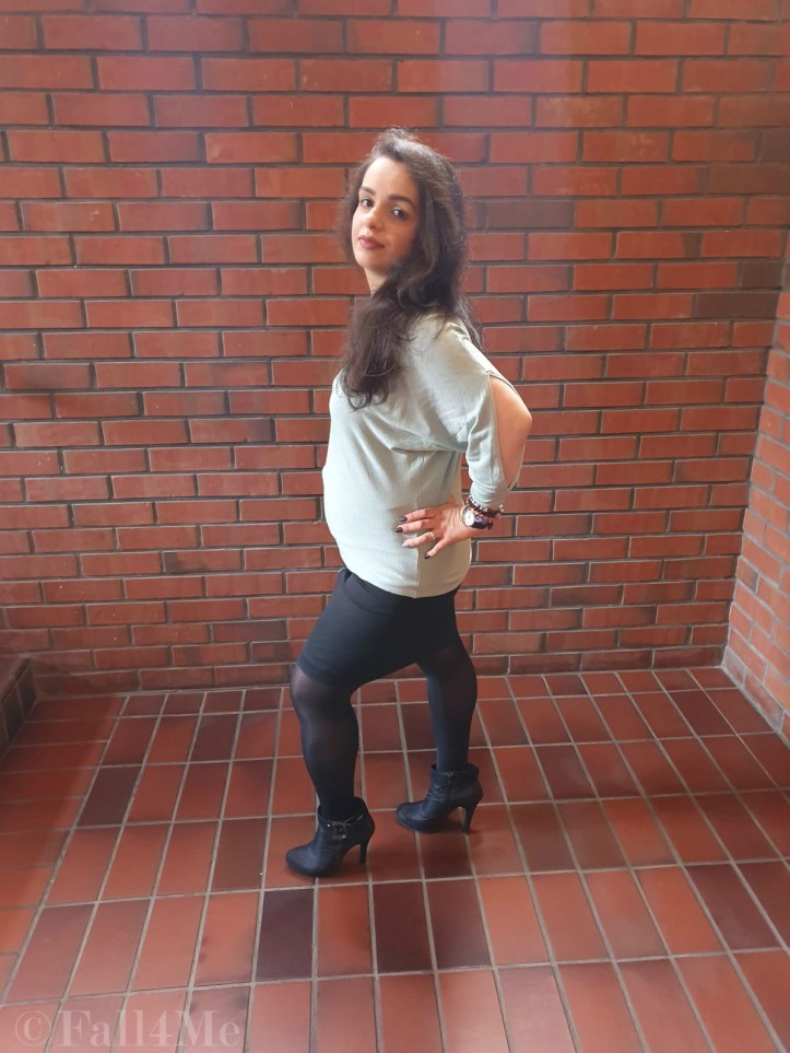 A black pencil skirt, opaque tights and high heels combined with a mint green summer pullover.