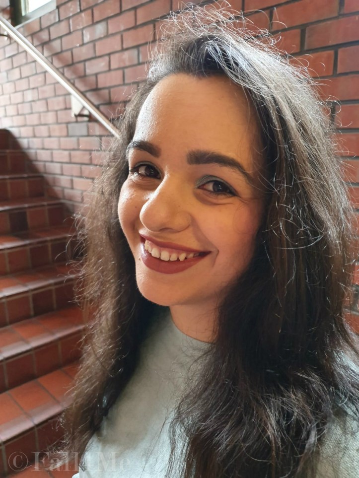 Jade green eye-shadow and pinkish-brown lipstick.