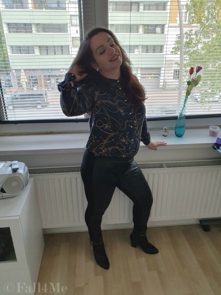 Trendy office chic: A trendy blouse with skinny black pants and boots.