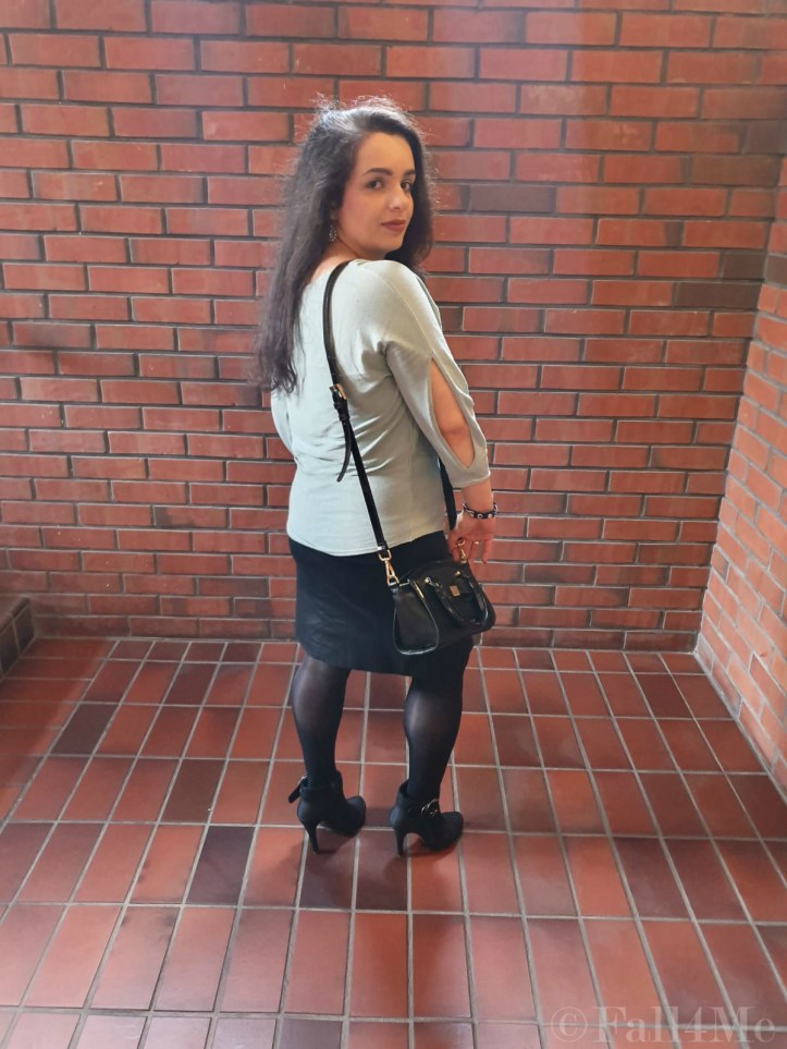 A black pencil skirt, opaque tights and high heels combined with a mint green summer pullover.