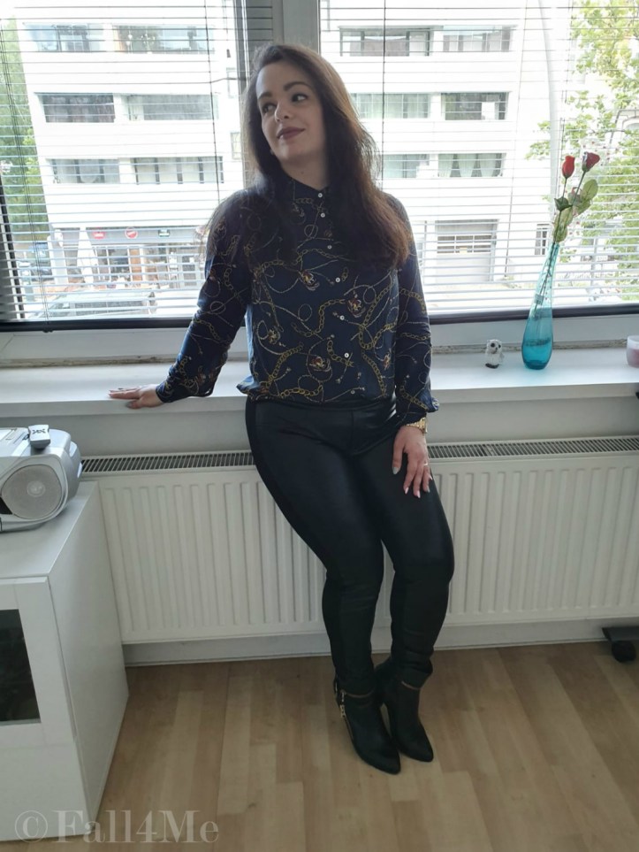 Trendy office chic: A trendy blouse with skinny black pants and boots.