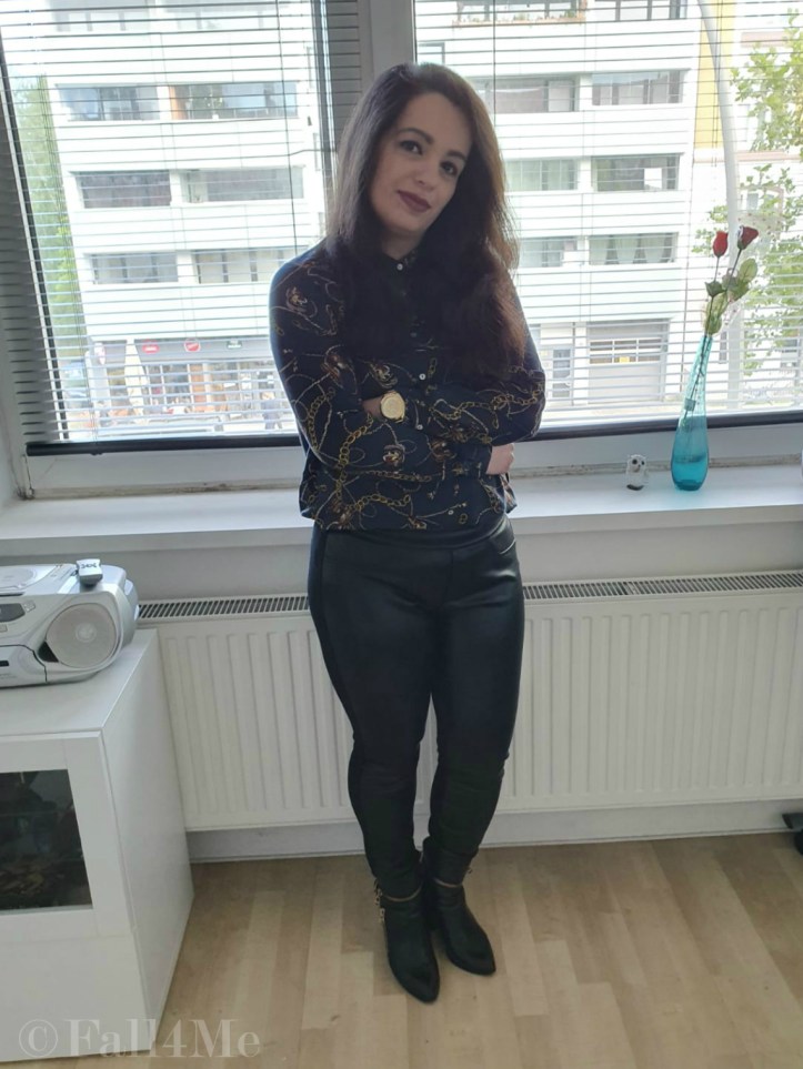 Trendy office chic: A trendy blouse with skinny black pants and boots.