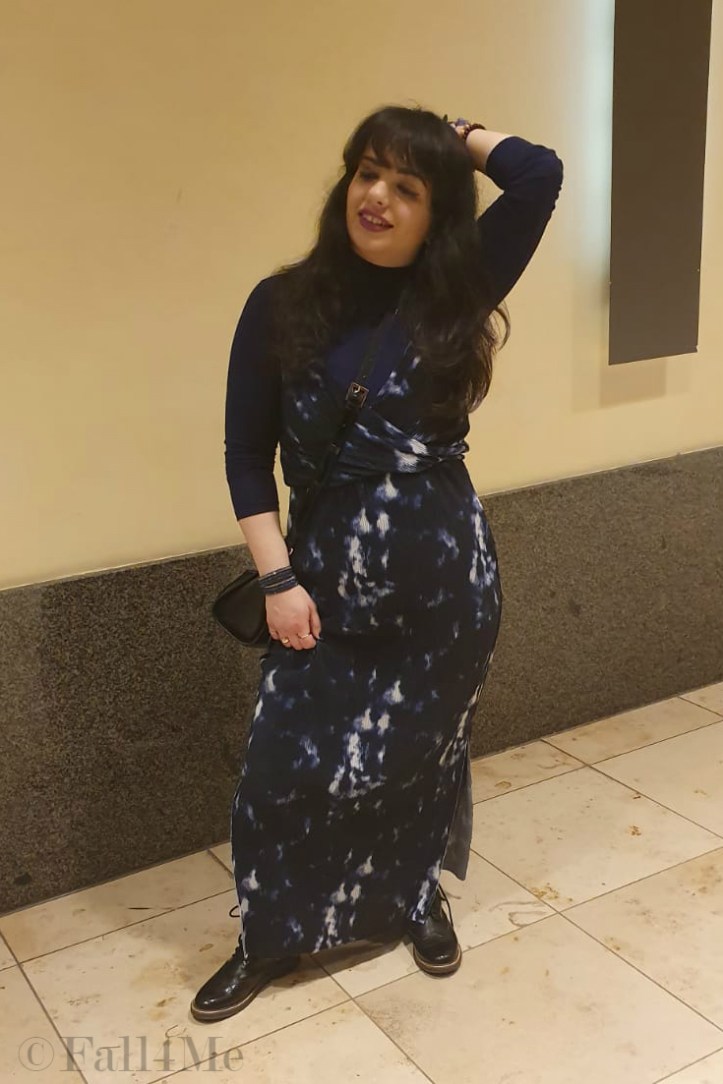 A maxi summer dress worn over a blue turtle neck. 