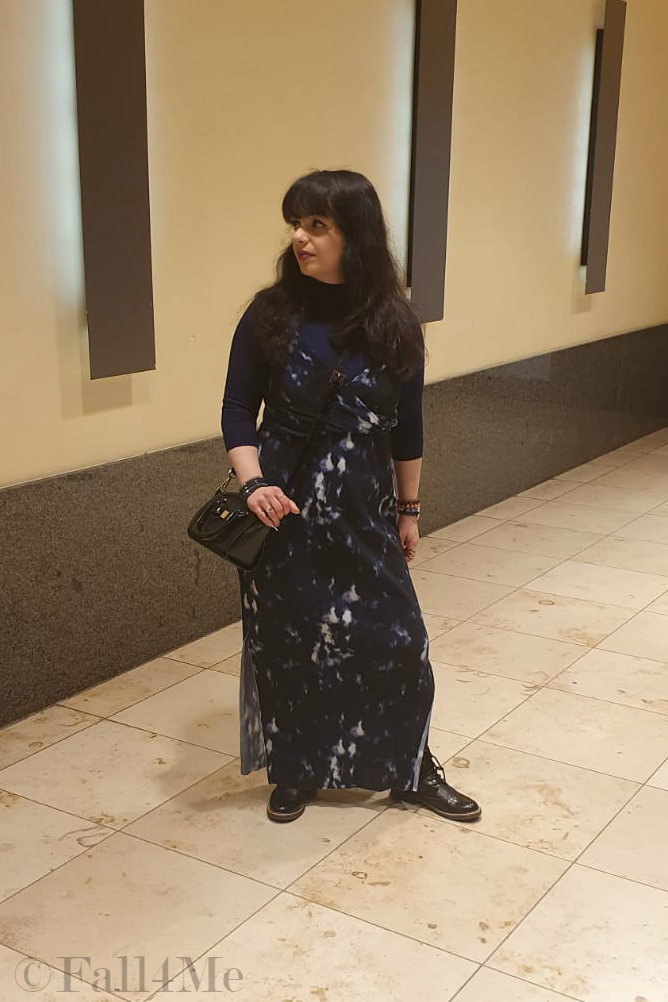 A maxi summer dress worn over a blue turtle neck. 