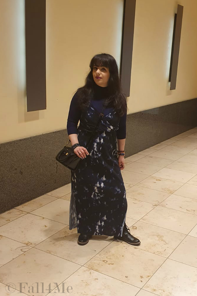 A maxi summer dress worn over a blue turtle neck. 