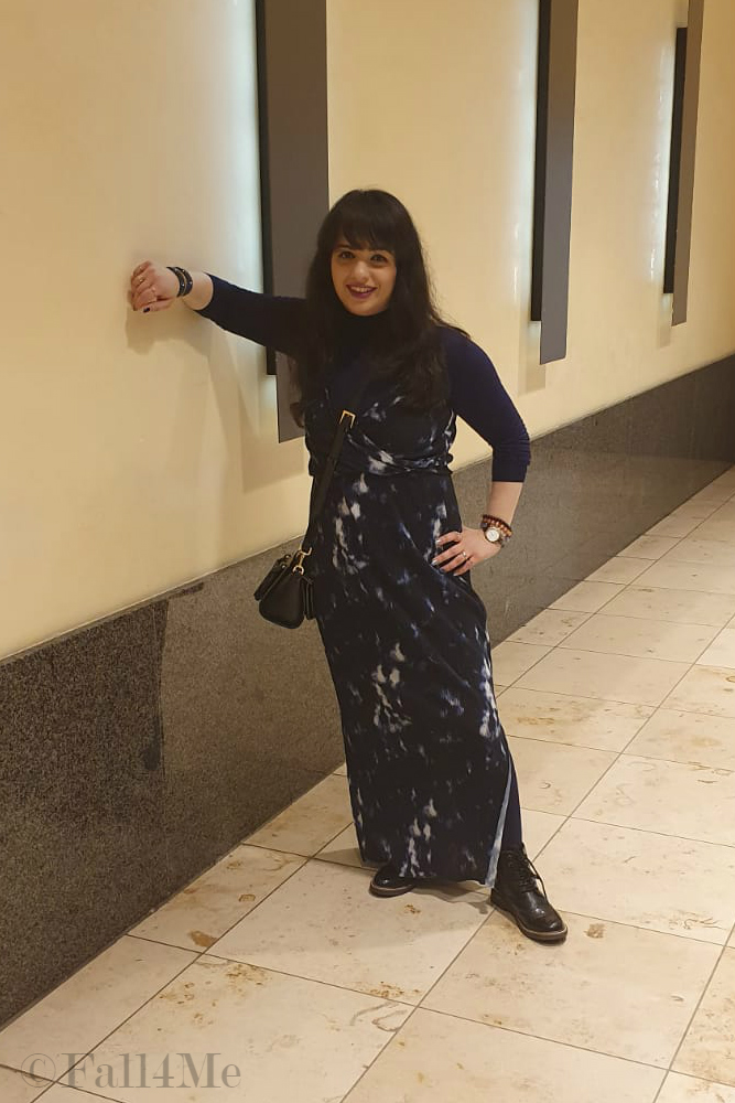 A maxi summer dress worn over a blue turtle neck. 