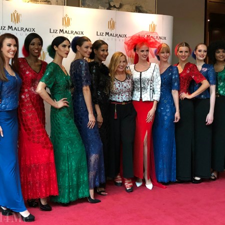 The designer in the center of her models and the host