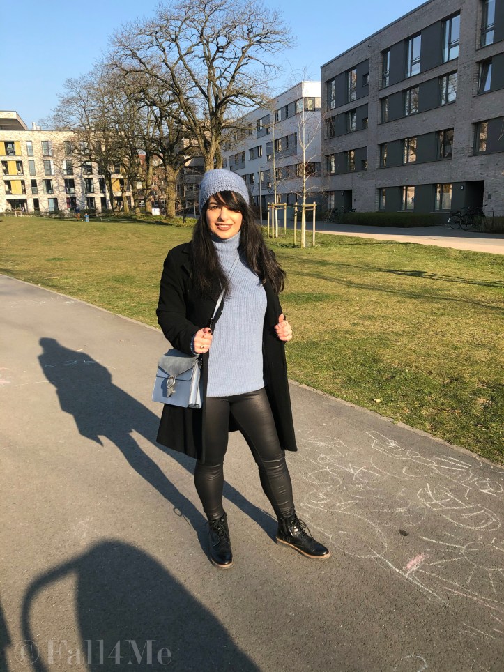 Steel-blue knit mixed with black leather and wool.