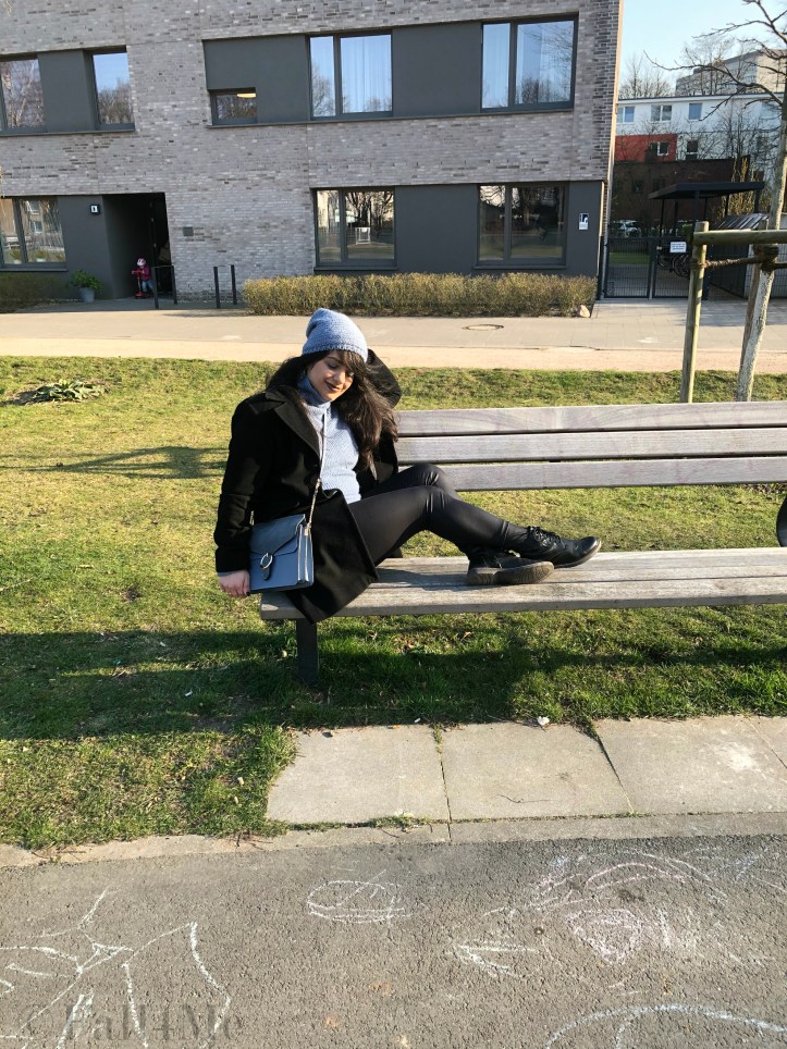 Steel-blue knit mixed with black leather and wool.