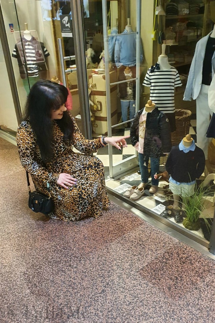 A leo-print dress styled with corresponding ankle boots and black accessories.