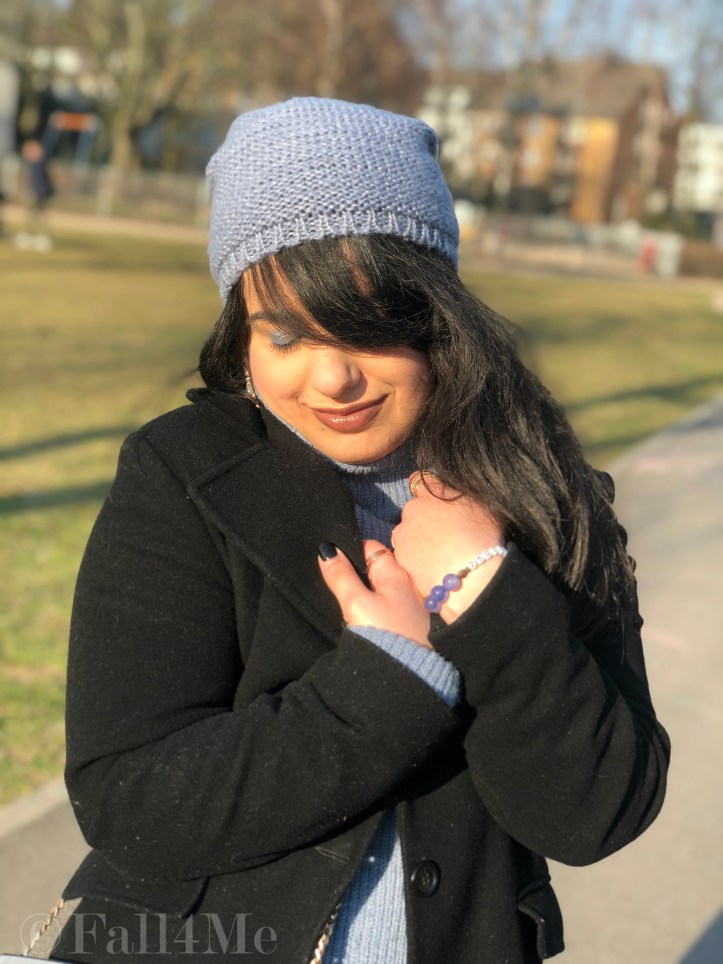 Steel-blue knit mixed with black leather and wool.