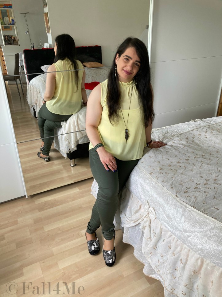 A lemon yellow shirt with oliv green pants.