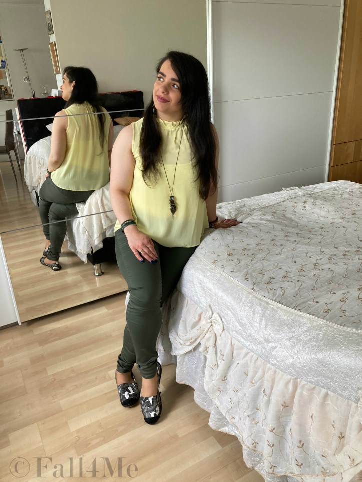 A lemon yellow shirt with oliv green pants.