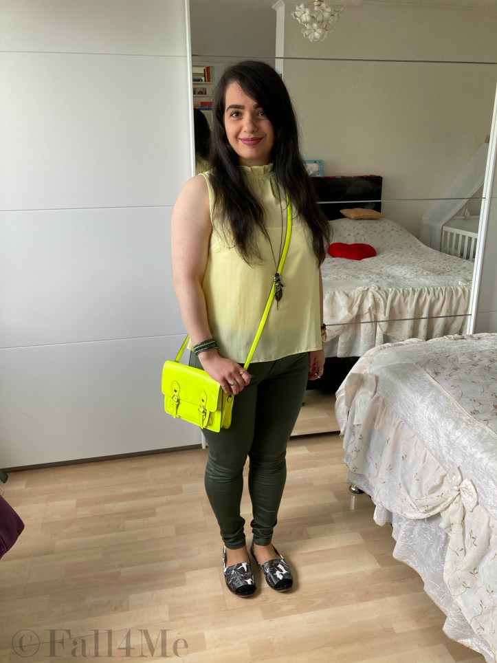 A lemon yellow shirt with oliv green pants.