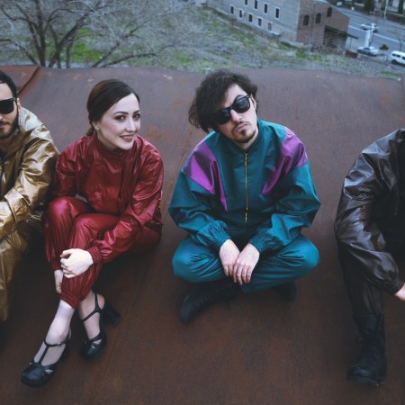 The members of the Nemra band sitting on a rooftop