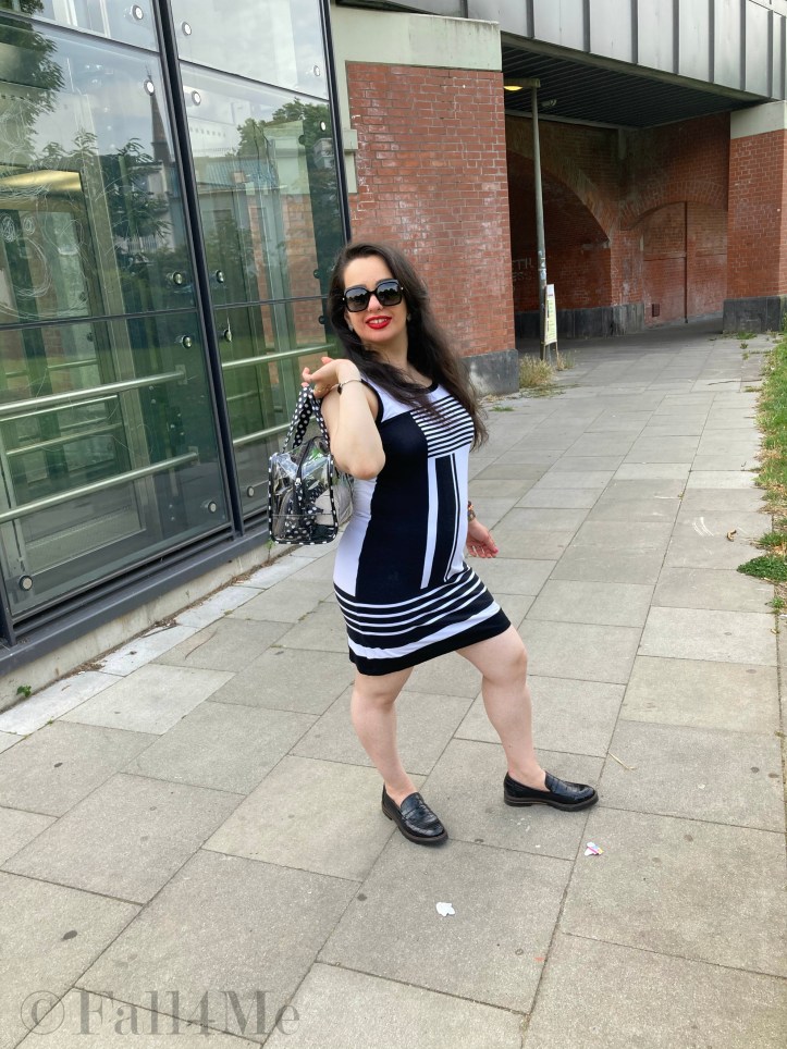 A black and white dress combined with red lips and a transparent handbag.