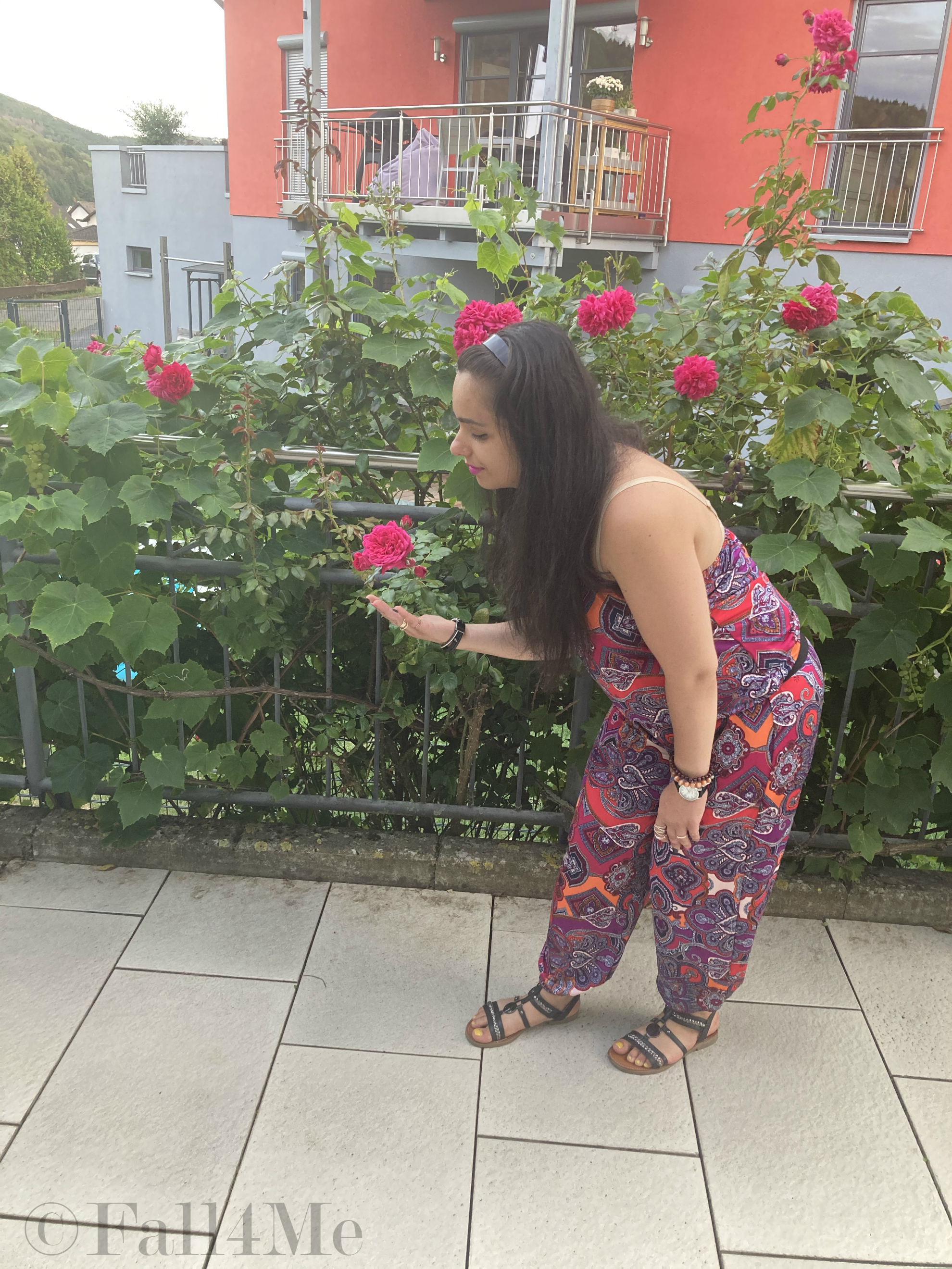 A jumpsuit in shades of raspberry combined with black.