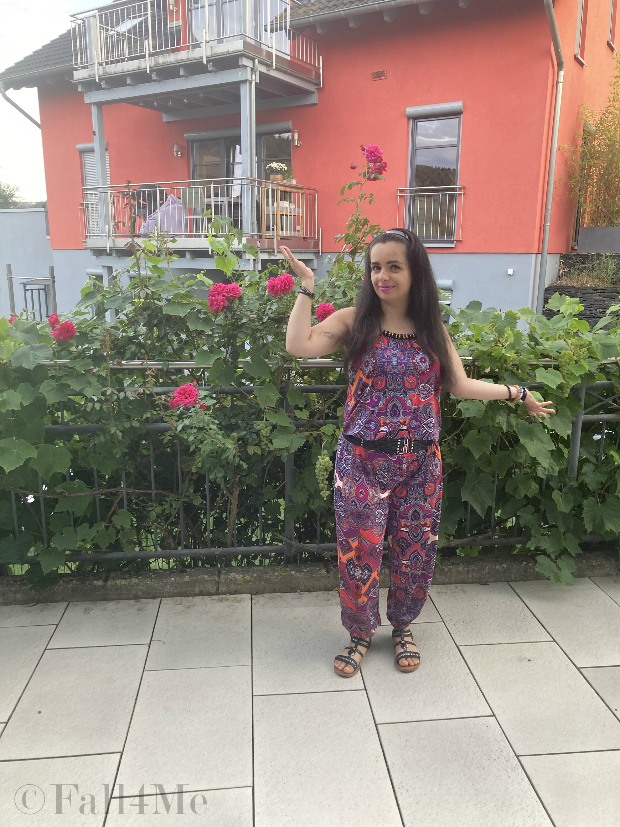 A jumpsuit in shades of raspberry combined with black.