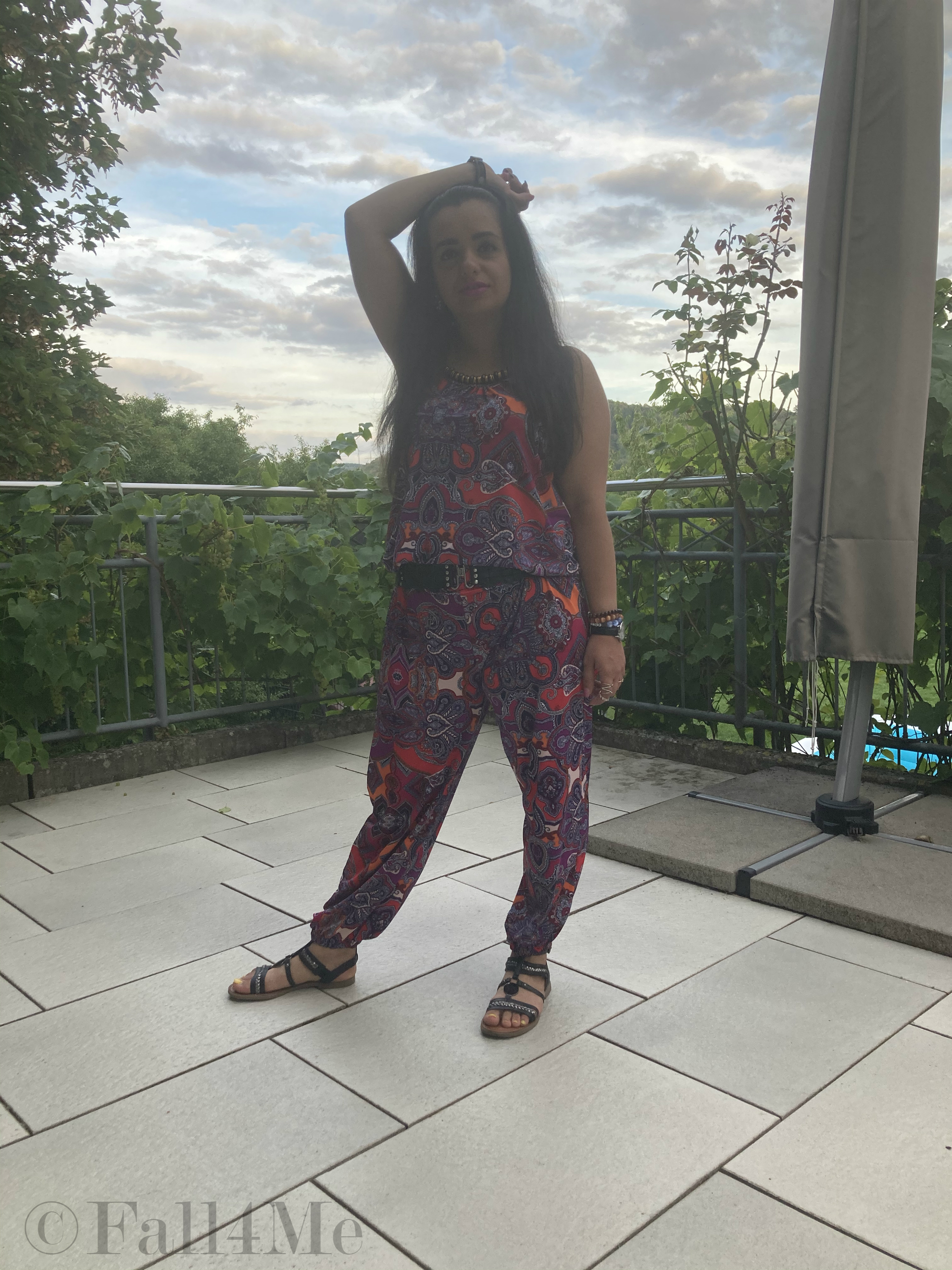 A jumpsuit in shades of raspberry combined with black.