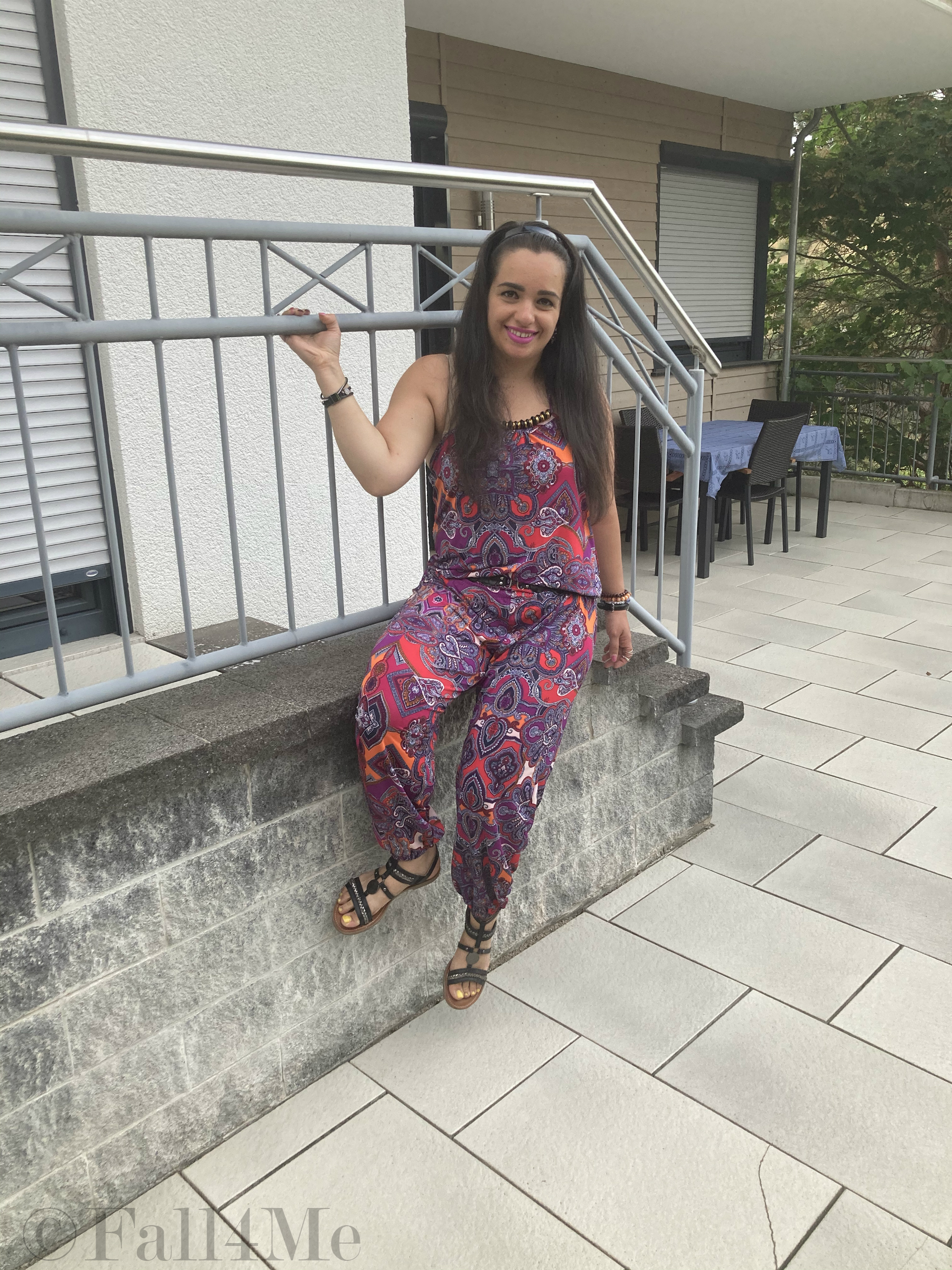 A jumpsuit in shades of raspberry combined with black.