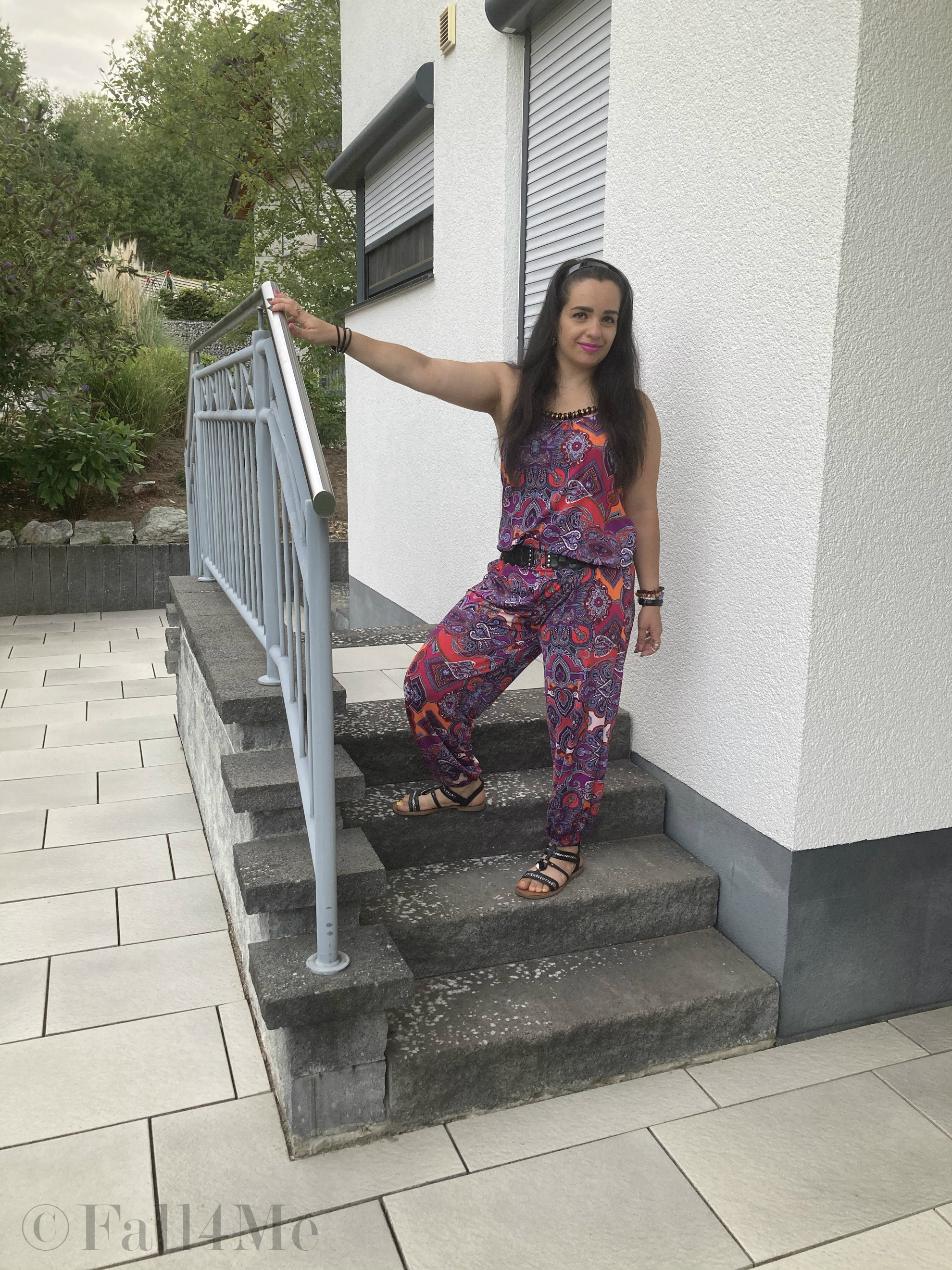 A jumpsuit in shades of raspberry combined with black.