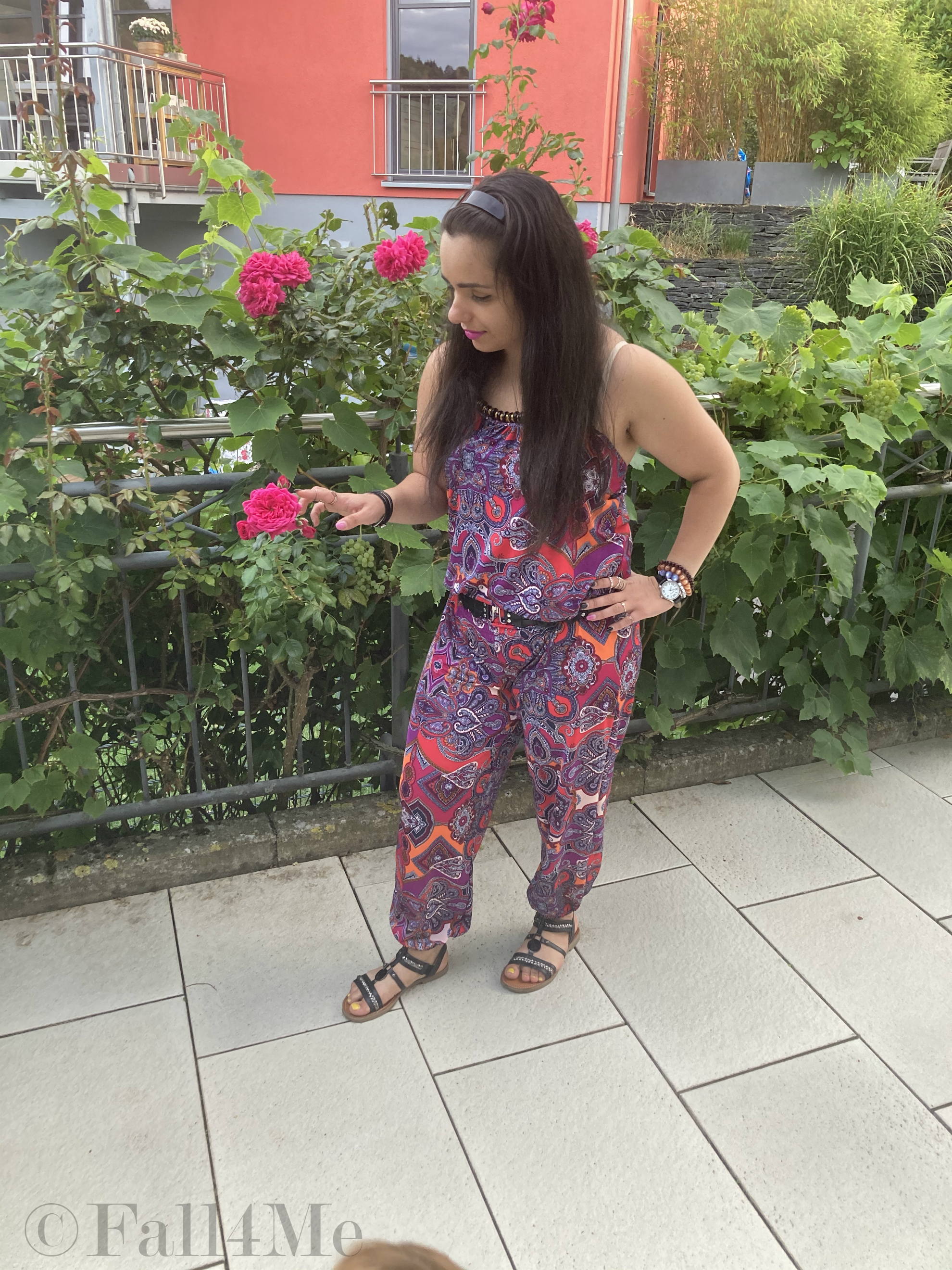 A jumpsuit in shades of raspberry combined with black.