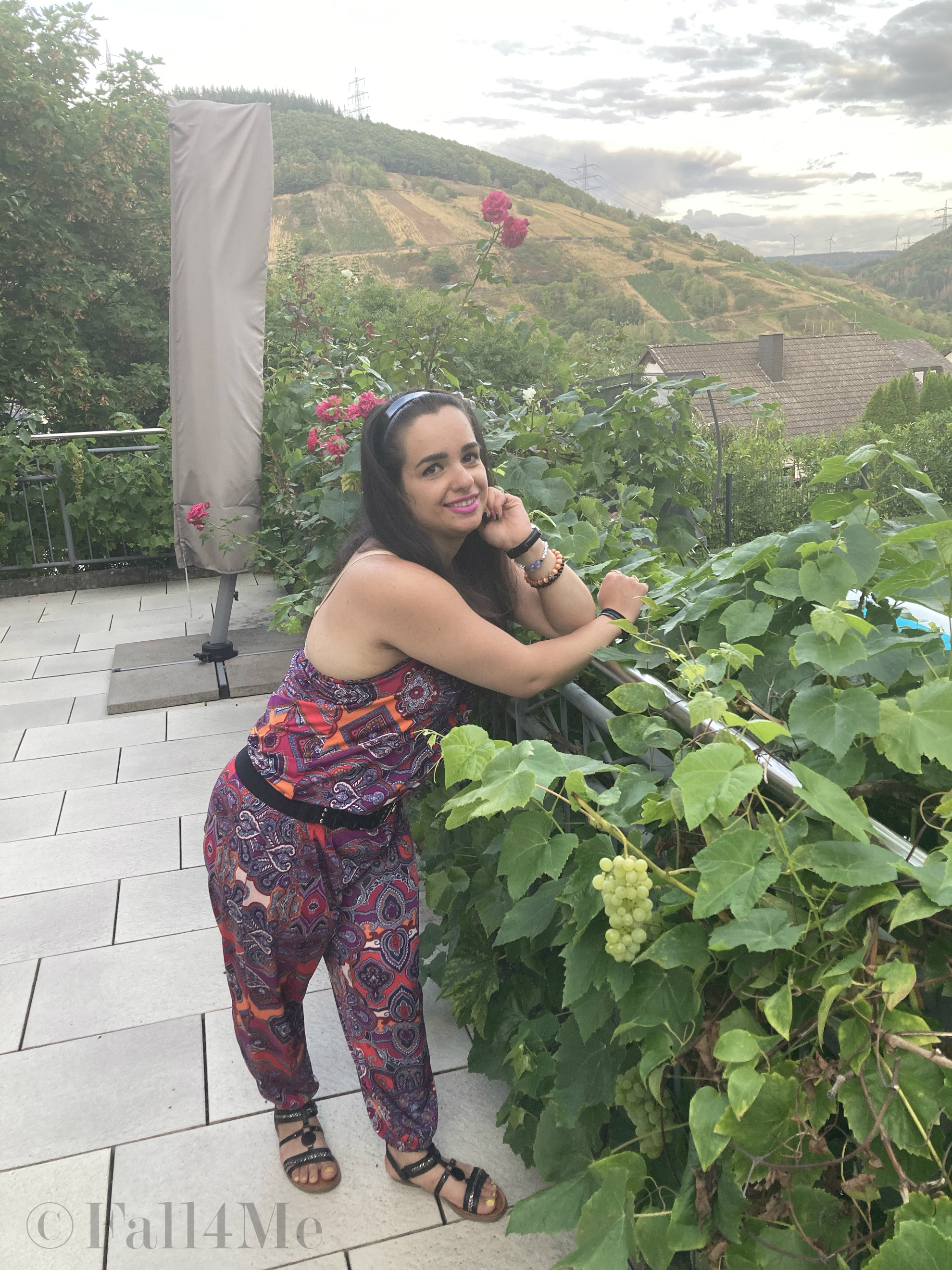 A jumpsuit in shades of raspberry combined with black.