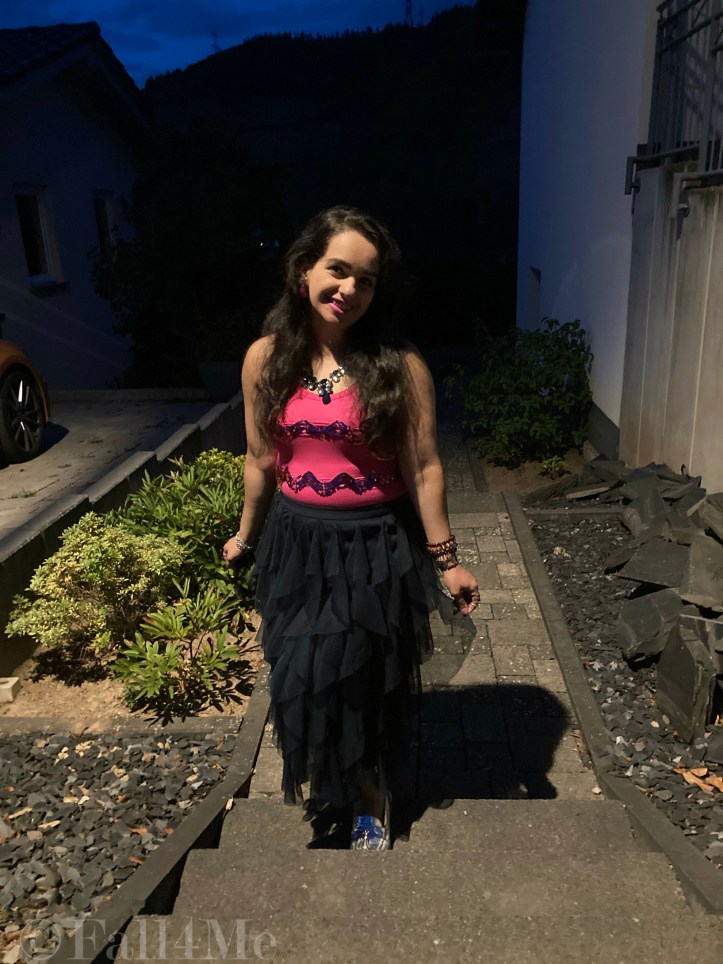 A navy blue tulle skirt combined with a pink sequins top.