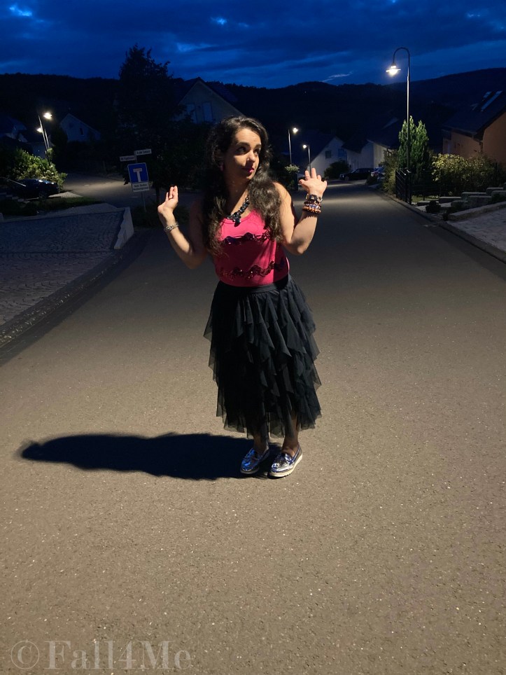 A navy blue tulle skirt combined with a pink sequins top.