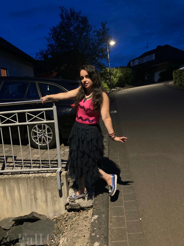 A navy blue tulle skirt combined with a pink sequins top.