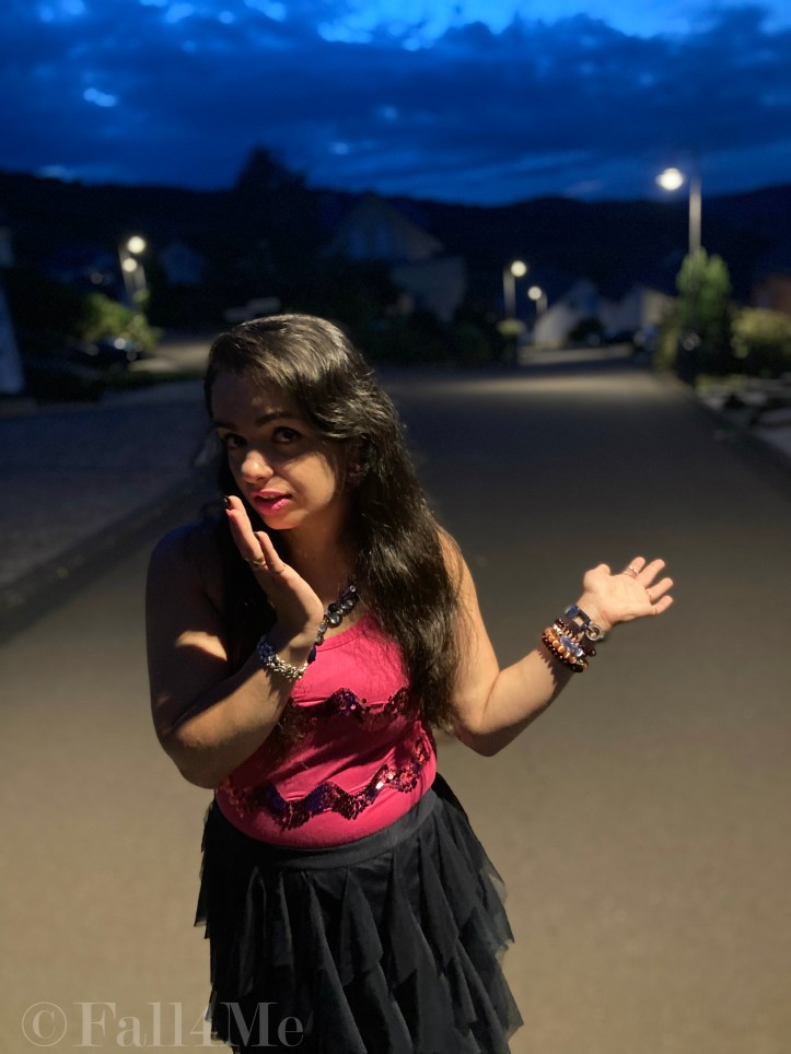 A navy blue tulle skirt combined with a pink sequins top.