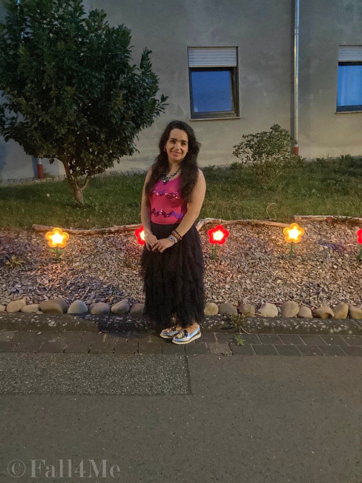 A navy blue tulle skirt combined with a pink sequins top.
